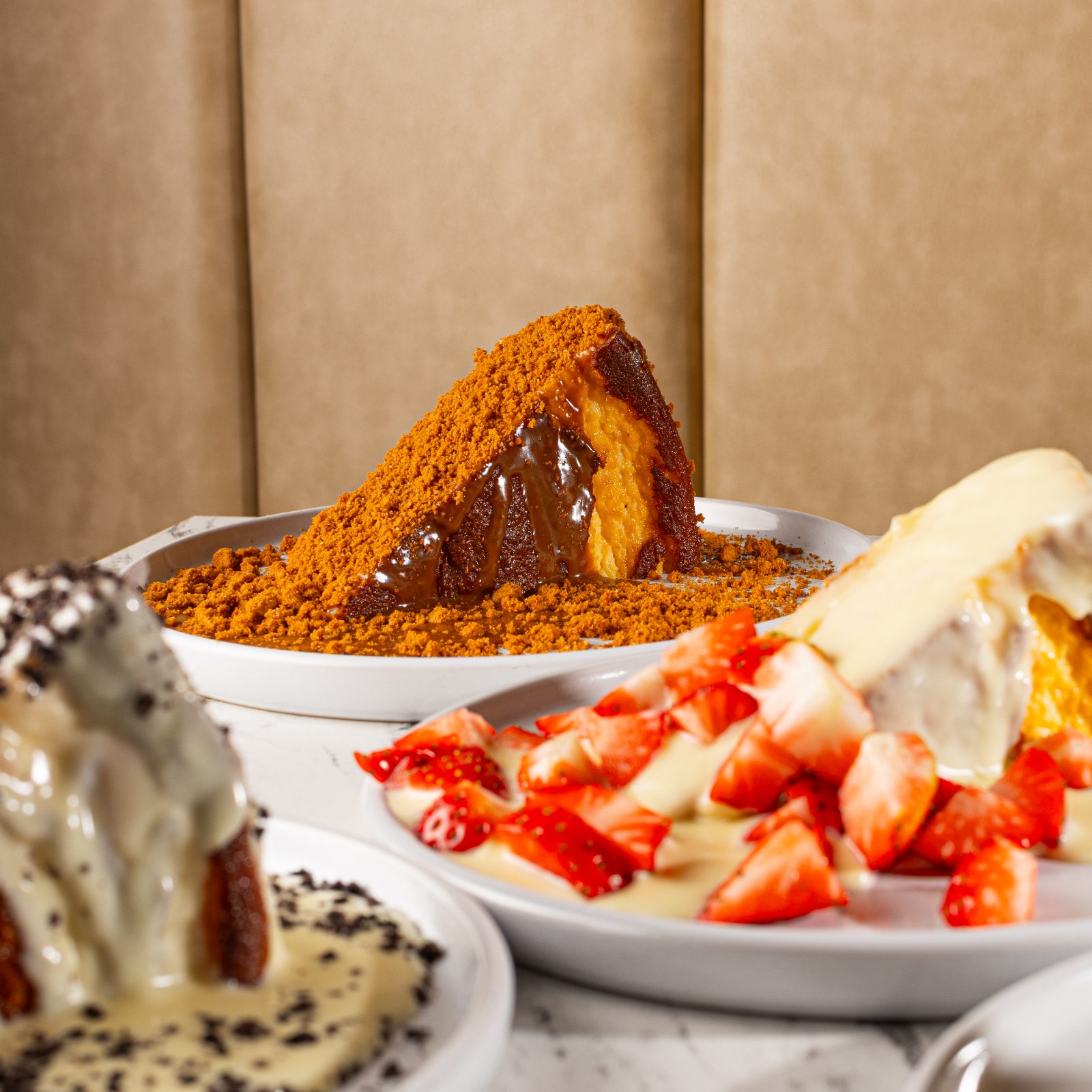 A trio of Dolci Vita Basque cheesecakes on marble
